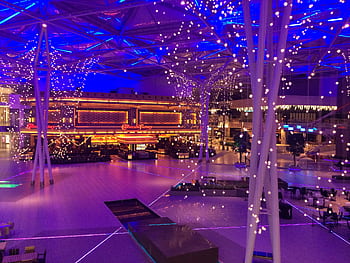 Bright and colorful interior of a Kuwait mall at night, showcasing vibrant lighting. HD wallpaper