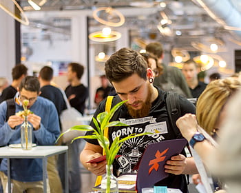 Group of young professionals networking in a modern indoor event. HD wallpaper