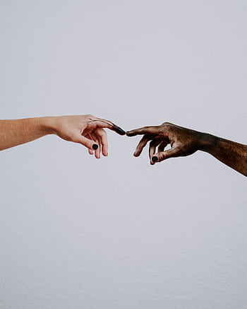 Two hands of different skin tones reaching out on a neutral background symbolizing unity. HD phone wallpaper