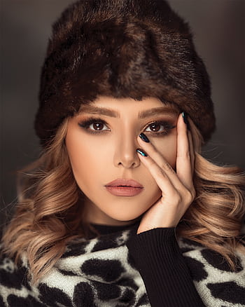 Close-up portrait of a woman in winter fashion with elegant makeup and fur hat. HD phone wallpaper
