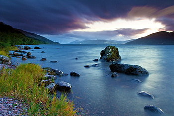 Beautiful View, colors, peaceful, beauty, mountains, water, sunset, landscape, beautiful, grass, rocks, lake, stormy, green, view, clouds, nature, sky, lovely, splendor, storm HD wallpaper
