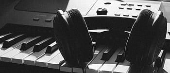 Close-up of heads resting on piano keys, capturing the essence of music creation. HD wallpaper