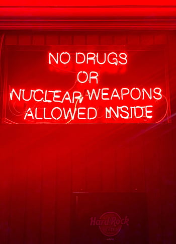Bright neon sign reading 'No drugs or nuclear weapons allowed inside' in a bar setting. HD phone wallpaper