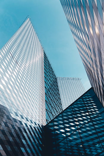 Futuristic skyscrapers in Vilnius with reflective geometric facades under a clear sky. HD phone wallpaper