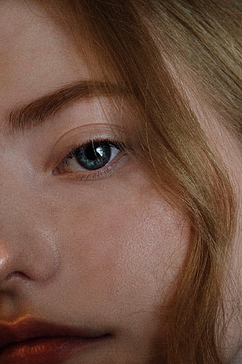 Intimate close-up of a woman's blue eye with blonde hair, capturing natural beauty. HD phone wallpaper