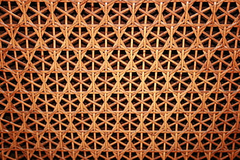 Close-up of a woven cane pattern showcasing intricate geometric design and natural texture. HD wallpaper