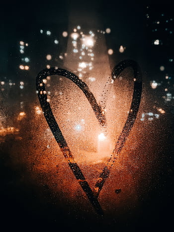 Heart shape drawn on a foggy window with city lights in the background, evoking romance and warmth. HD phone wallpaper