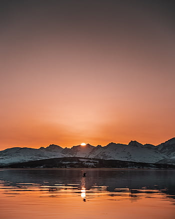 Capture of a breathtaking sunset over a tranquil mountain lake with a fiery sky. HD phone wallpaper