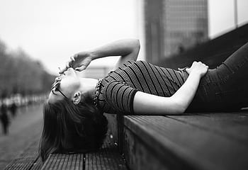 Black and white of a woman reclining on urban stairs, smoking. HD wallpaper