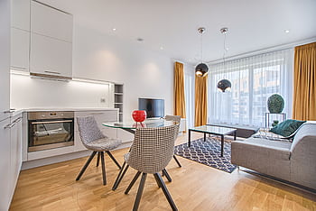 Elegant Scandinavian-style living room and kitchen featuring modern furniture and decor. HD wallpaper