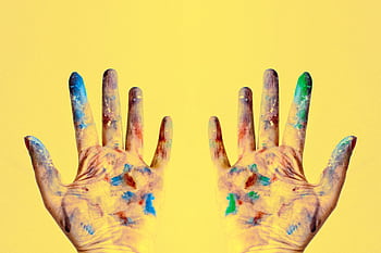 Colorful fingers spread against a bright yellow backdrop, showcasing creativity. HD wallpaper