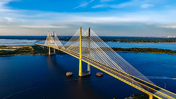 Stunning aerial shot of the Dames Point Bridge spanning over blue waters under a clear sky. HD wallpaper