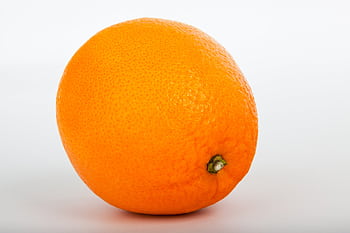 Bright and fresh orange isolated on a white background, perfect for food and health themes. HD wallpaper