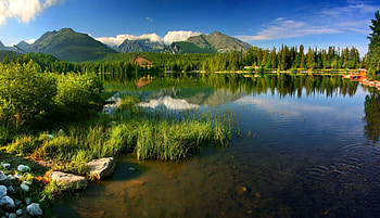 Lake in high Tatras-Slovakia, Tatras, crystal, peaks, nice, shore, reflection, chalet, Slovakia, beautiful, grass, rocks, lake, stones, mountain, summer, cliffs, mirrored, pretty, nature, sky, clear, lovely HD wallpaper
