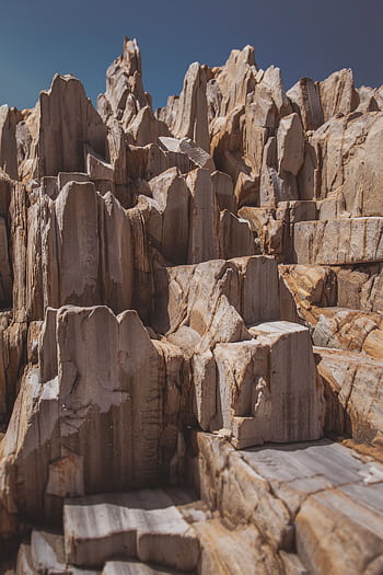 Captivating sandstone formations under clear sky, highlighting geological beauty. HD phone wallpaper