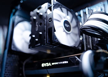 Detailed view of a cooling fan inside a modern gaming PC setup. HD wallpaper