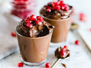 Luscious chocolate mousse topped with fresh pomegranate seeds, perfect for dessert lovers. HD wallpaper