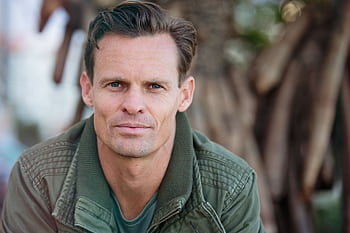 Close-up portrait of a man wearing a casual jacket outdoors. HD wallpaper