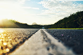 Serene road stretching through lush landscape during sunset in Kangar, Malaysia. HD wallpaper