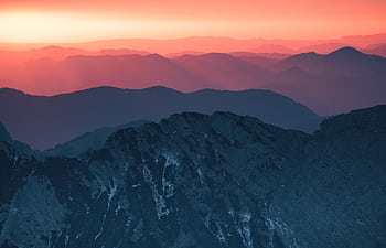 Stunning sunset view over the Julian Alps with vivid colors and scenic mountain layers. HD wallpaper