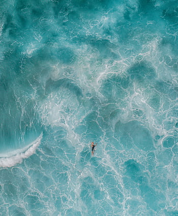 Stunning aerial shot of a lone swimmer in the vibrant turquoise ocean at Bronte, Australia. HD phone wallpaper