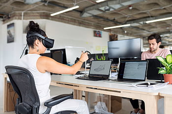 Woman using virtual reality headset in a modern office for design and innovation. HD wallpaper