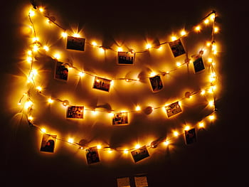 Cozy arrangement of fairy lights displaying graphs in a dark room setting. HD wallpaper