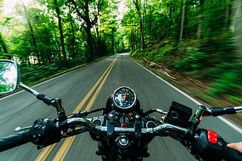 Experience the thrill of a motorcycle ride through a scenic, winding forest road. Feel the speed and dom. HD wallpaper