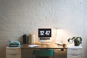 Elegant workspace featuring a computer on a sleek desk, ideal for work and creativity. HD wallpaper