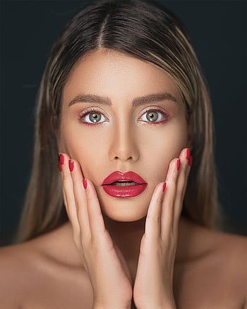 Close-up portrait of a woman showcasing red lips and nails, emphasizing beauty and elegance. HD phone wallpaper