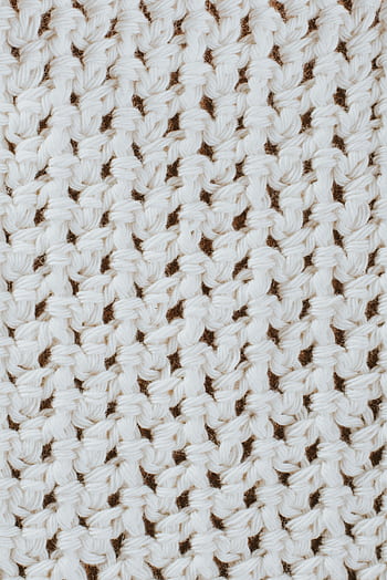Detailed view of white knitted texture showcasing intricate patterns. HD phone wallpaper