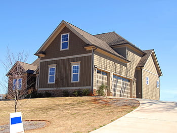 Cozy family home for sale in suburb with spacious garage and landscaped lawn. HD wallpaper