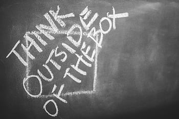 Chalkboard with 'Think Outside the Box' handwritten, inspiring creativity. HD wallpaper