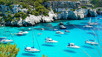 Boats At Stony Coast, sea, cliff, clear, water, rocks HD wallpaper