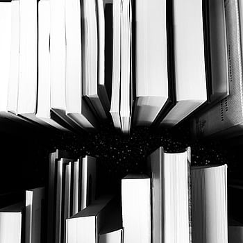 Artistic black and white of vertically arranged books viewed from above, showcasing a unique perspective. HD phone wallpaper