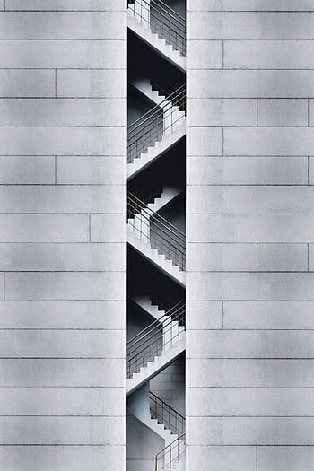 An artistic view of a modern staircase embedded in a concrete building facade in Taipei, Taiwan. HD phone wallpaper