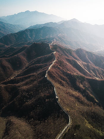 Stunning aerial shot of the Great Wall of China winding through mountains in autumn. HD phone wallpaper
