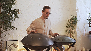 Man playing steel tongue drums, stock video, Rhythmic beats, Melodic instrument HD wallpaper