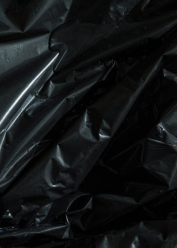 Close-up of crumpled black plastic with texture and light reflections. HD phone wallpaper