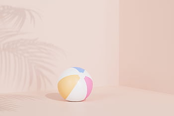 Bright pastel beach ball on beige backdrop with palm shadow, perfect for summer vibes. HD wallpaper