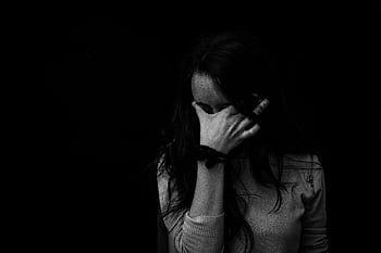 Intense black and white portrait capturing the emotion and introspection of a woman covering her face. HD wallpaper