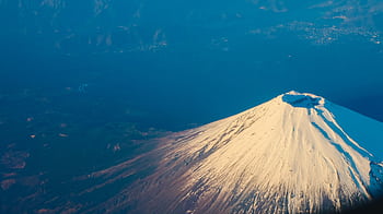 Stunning aerial view of Mount Fuji's snow-capped peak during winter, capturing its majestic beauty. HD wallpaper