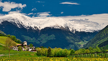 Beautiful Mountains Houses Trees Yellow Flowers Field Bushes Plants Greenery Land Snow Under White Clouds Blue Sky Nature HD wallpaper