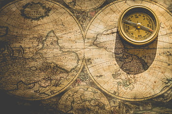 Antique map with a compass, symbolizing exploration and navigation. HD wallpaper