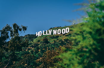 A scenic view of the famous Hollywood sign on a sunny day in Los Angeles. HD wallpaper