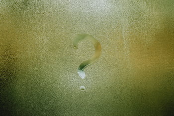 A question mark drawn on foggy glass, evoking curiosity and mystery. HD wallpaper