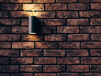 Contemporary brick wall design featuring a sleek accent light. HD wallpaper