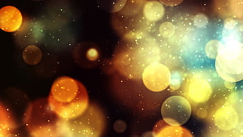 Vibrant bokeh background with golden and blue lights creates a magical and festive atmosphere. HD wallpaper