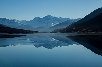 Peaceful mountain landscape with clear reflections in a calm lake. HD wallpaper