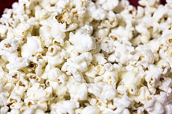 Delicious and fluffy popcorn kernels in a close-up shot ready to enjoy. HD wallpaper